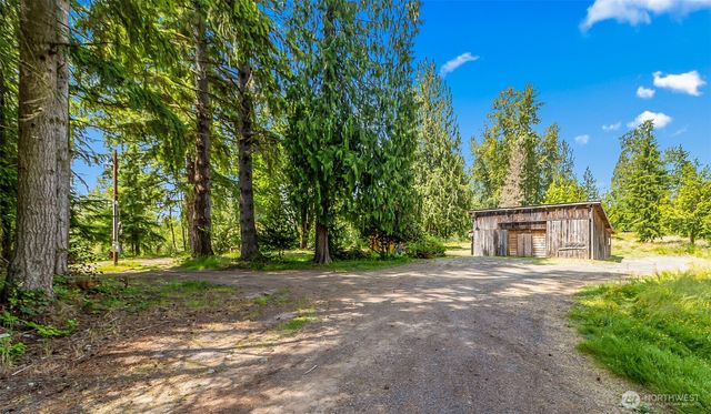 a view of a house with a yard and tree s