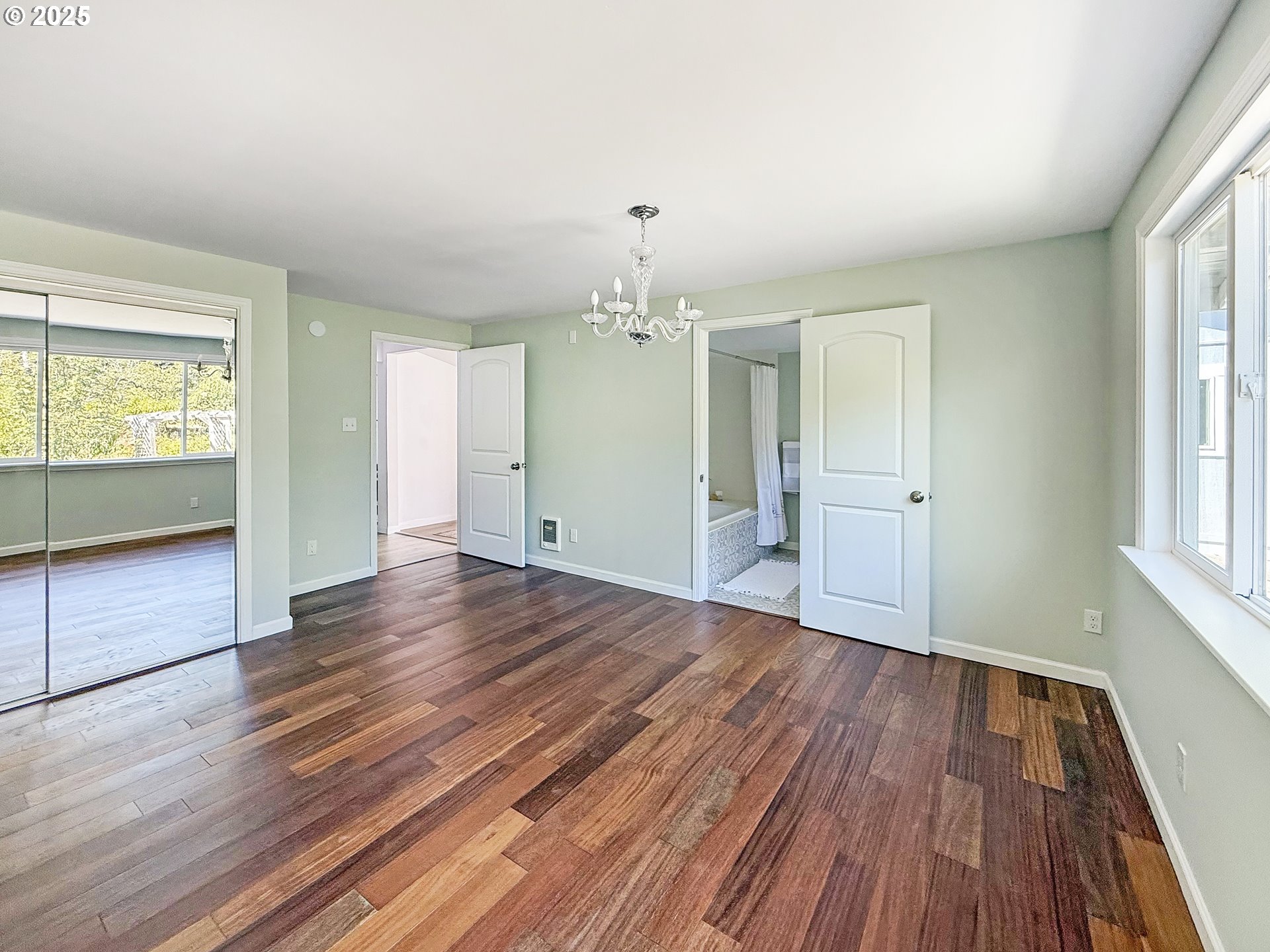 97040 Henderson Road Brookings, OR 97415 - Photo 12 of 36 an empty room with wooden floor and windows