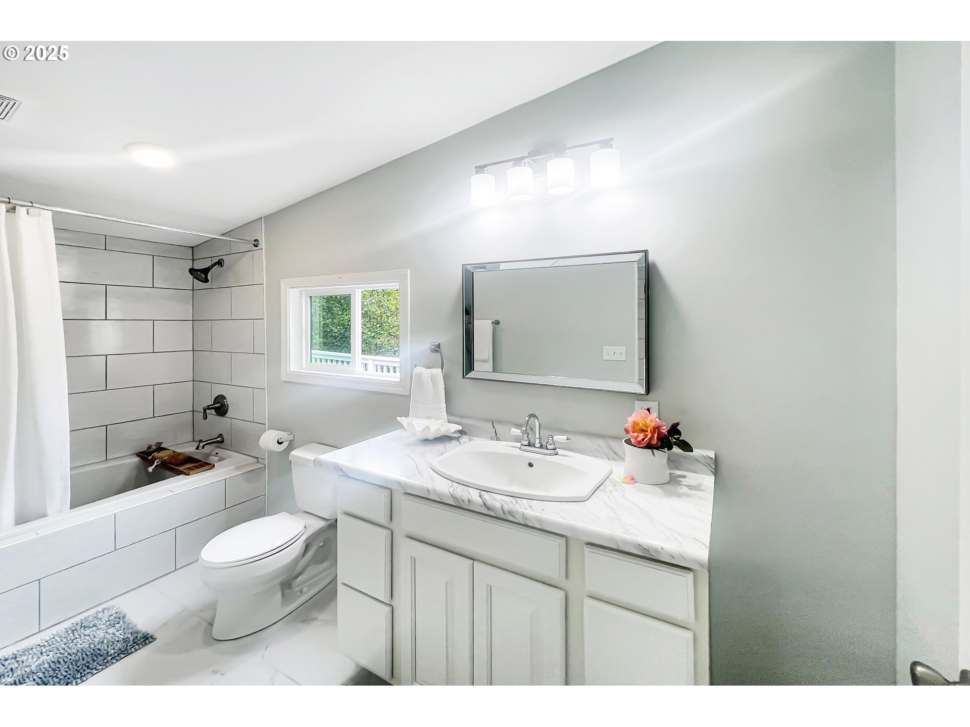 97040 Henderson Road Brookings, OR 97415 - Photo 13 of 36 a bathroom with a toilet a sink a mirror a window and vanity