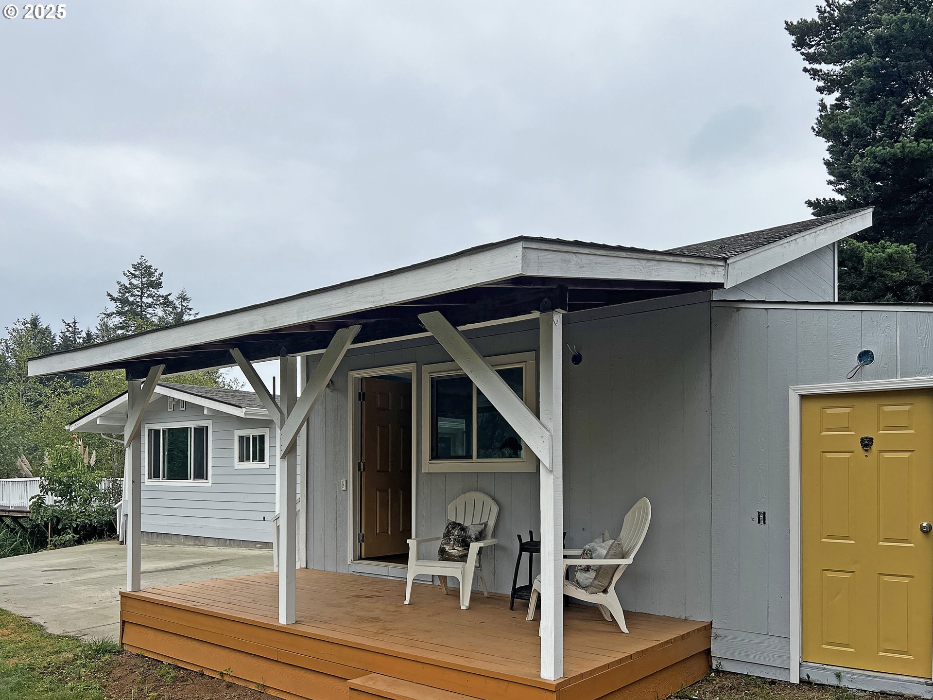 97040 Henderson Road Brookings, OR 97415 - Photo 25 of 36 a front view of a house with porch