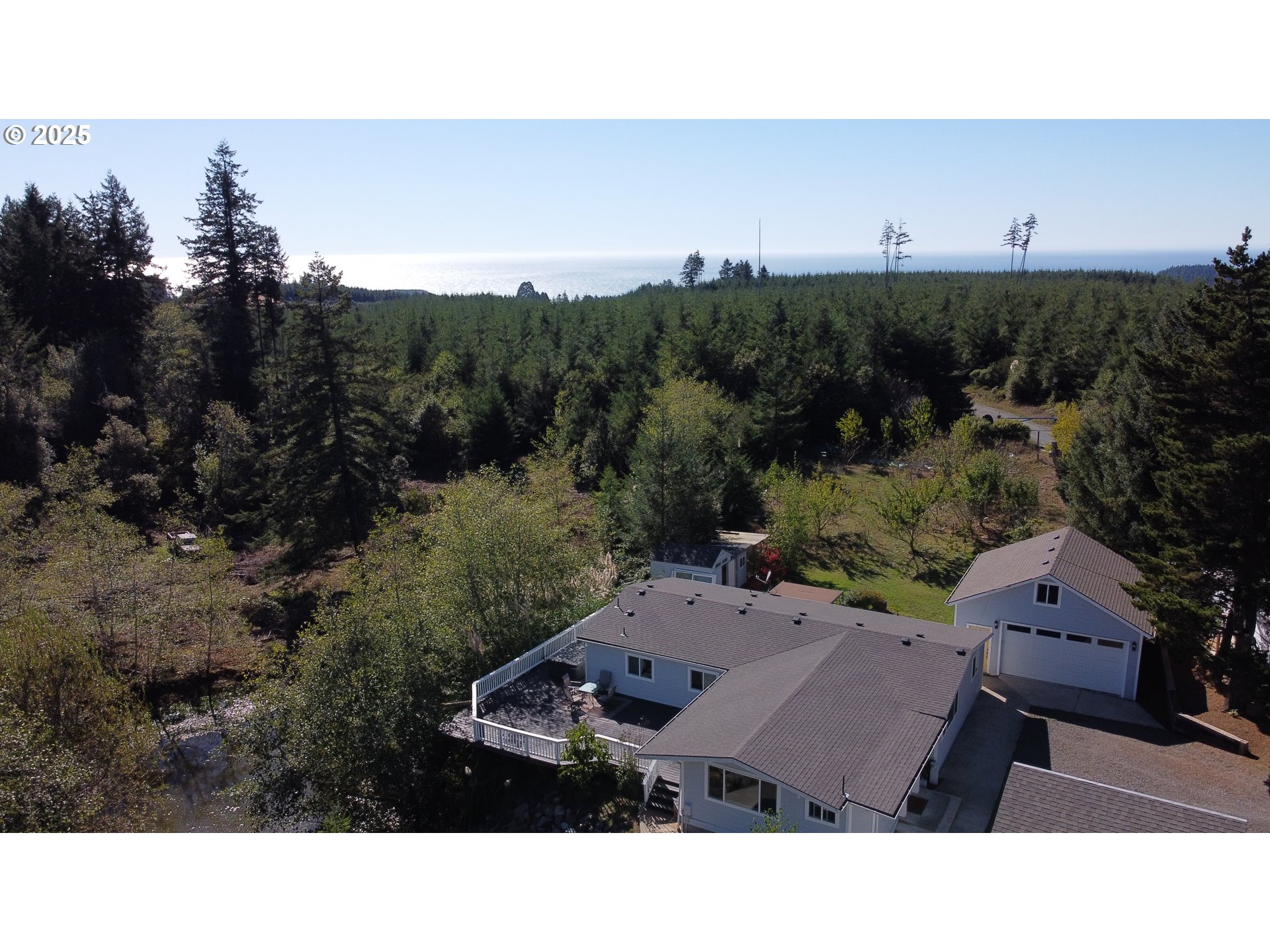 97040 Henderson Road Brookings, OR 97415 - Photo 34 of 36 a aerial view of a house with lots of trees