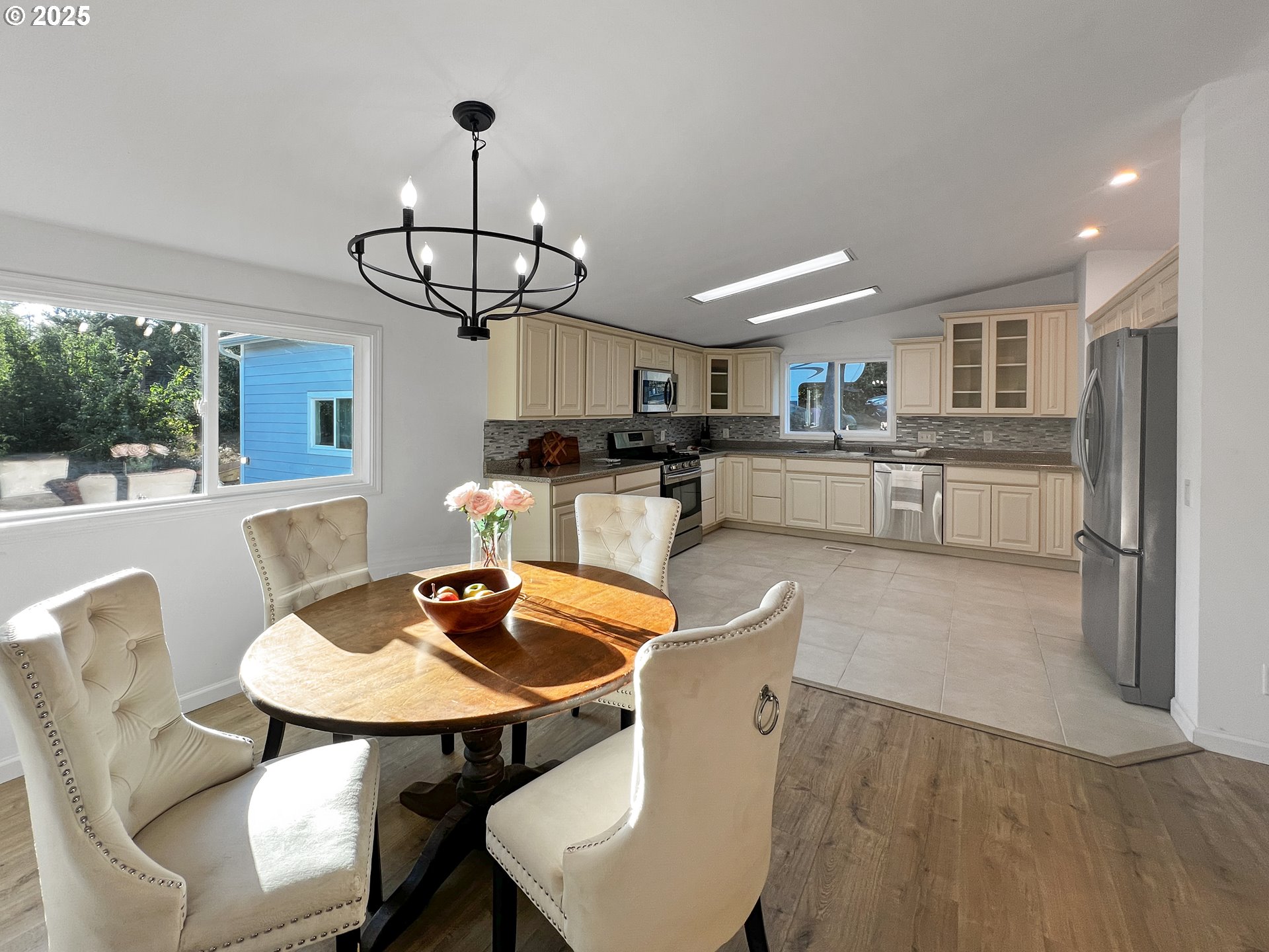 97040 Henderson Road Brookings, OR 97415 - Photo 5 of 36 a view of a dining room with furniture a chandelier and wooden floor