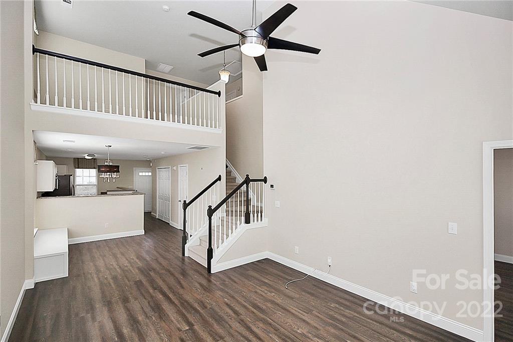 11630 Rabbit Ridge Road Charlotte, NC 28270 - Photo 12 of 32 a view of staircase with wooden floor and white walls