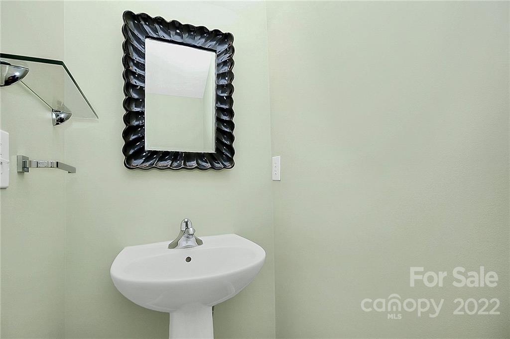 11630 Rabbit Ridge Road Charlotte, NC 28270 - Photo 14 of 32 a bathroom with a sink and mirror