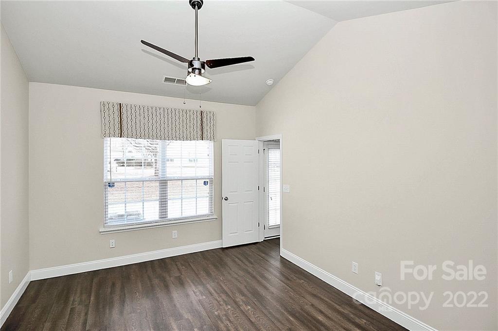 11630 Rabbit Ridge Road Charlotte, NC 28270 - Photo 17 of 32 a view of a kitchen with wooden floor a ceiling fan and windows