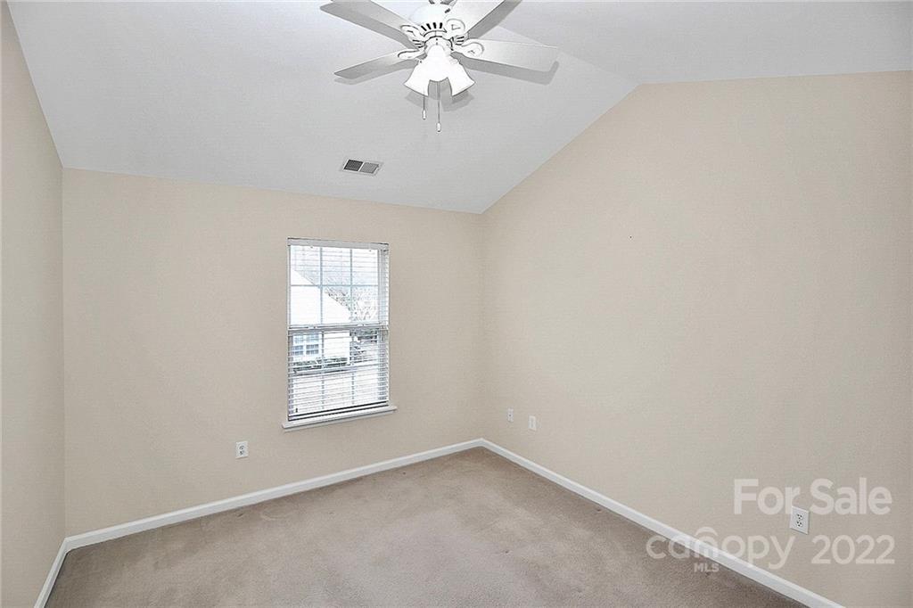 11630 Rabbit Ridge Road Charlotte, NC 28270 - Photo 26 of 32 an empty room with windows and fan