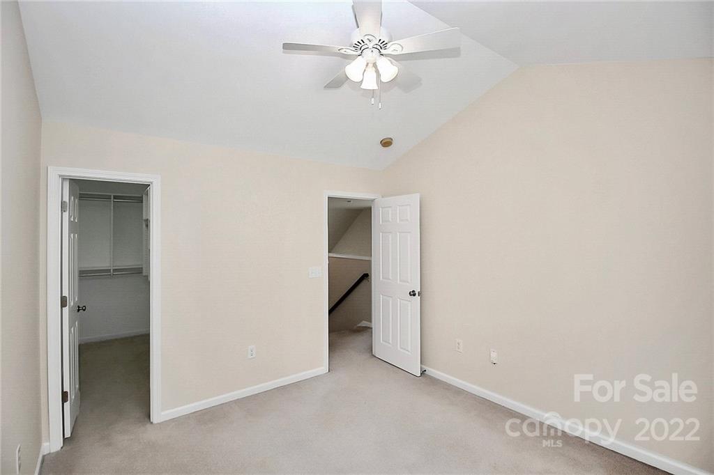 11630 Rabbit Ridge Road Charlotte, NC 28270 - Photo 27 of 32 an empty room with a ceiling fan and a window