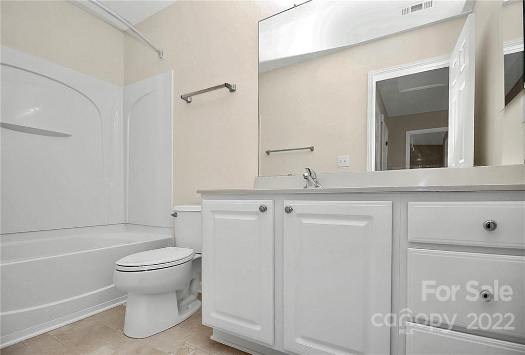 11630 Rabbit Ridge Road Charlotte, NC 28270 - Photo 29 of 32 a bathroom with a granite countertop toilet sink and mirror