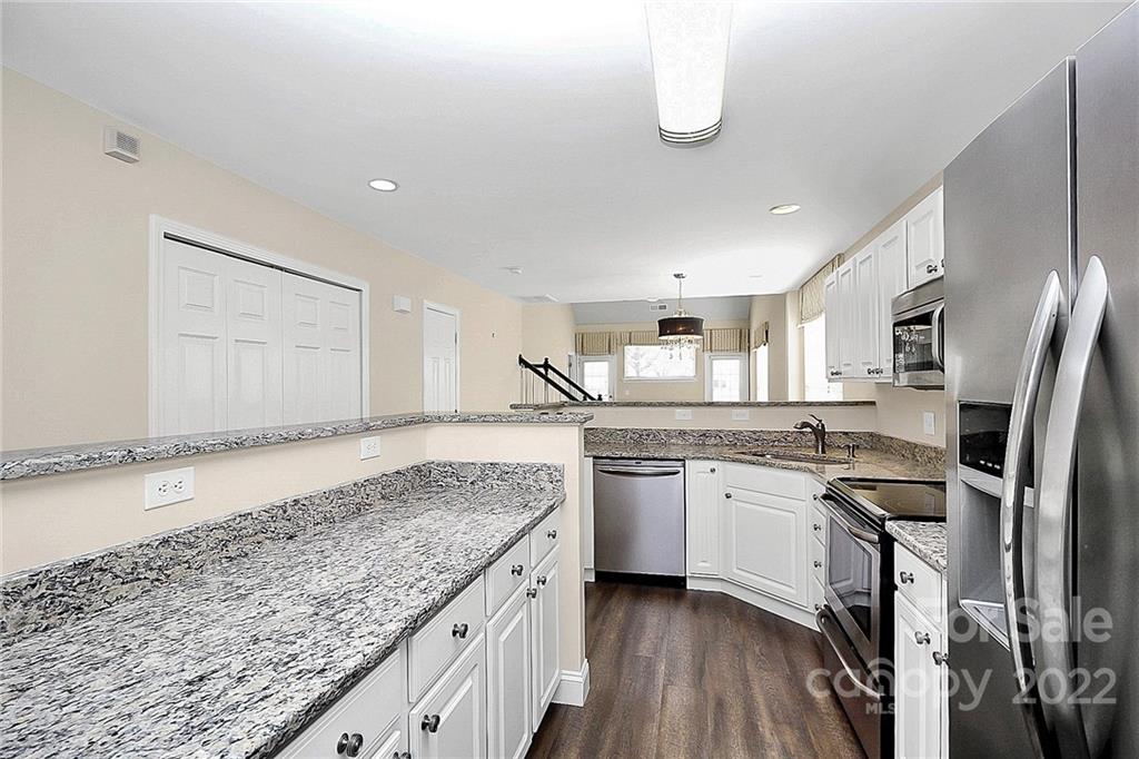 11630 Rabbit Ridge Road Charlotte, NC 28270 - Photo 7 of 32 a kitchen with stainless steel appliances granite countertop a sink stove and refrigerator