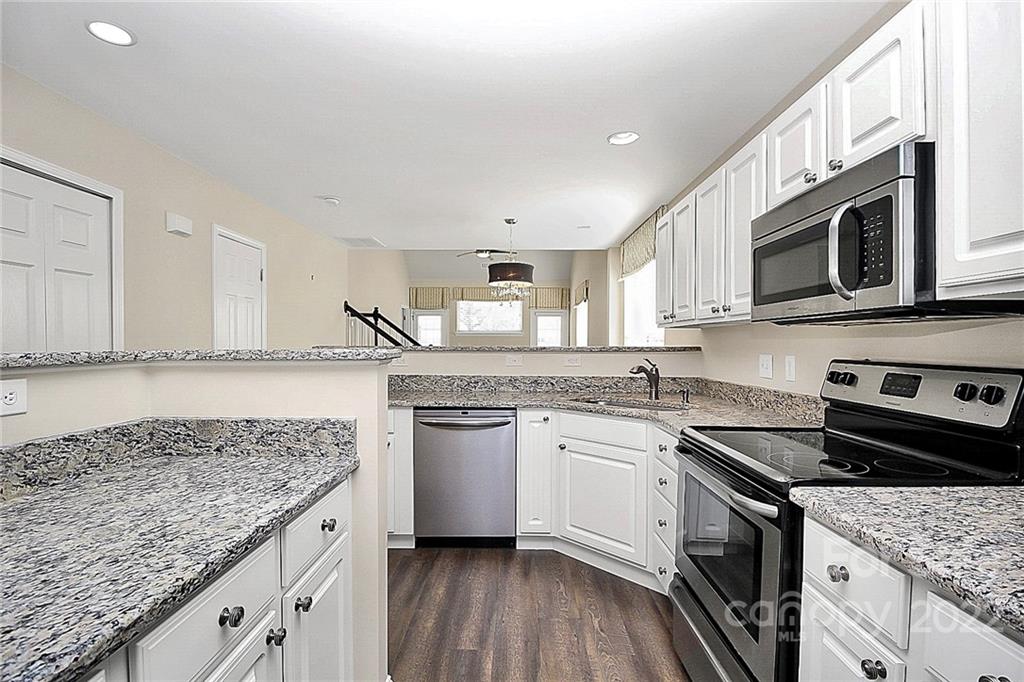 11630 Rabbit Ridge Road Charlotte, NC 28270 - Photo 8 of 32 a kitchen with stainless steel appliances granite countertop a stove and a sink