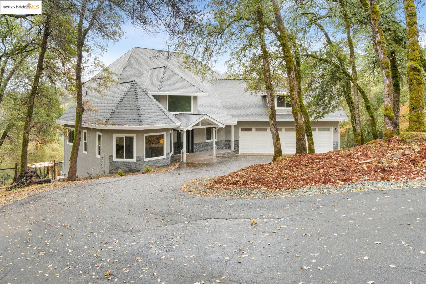 a front view of a house with a dirt yard