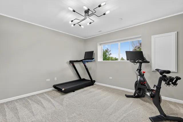 a room with gym equipment and windows
