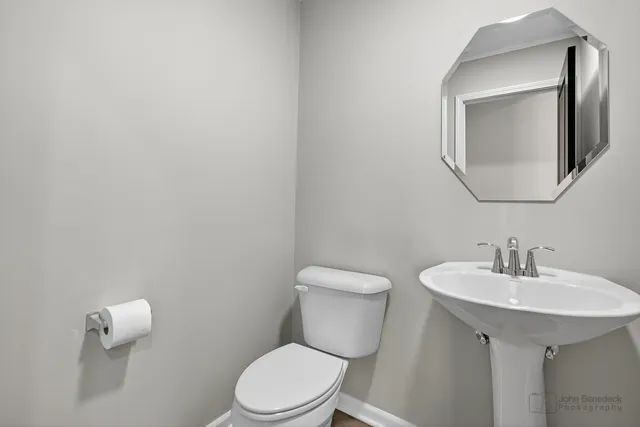 a white toilet sitting next to a bathroom sink