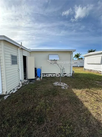 a front view of a building with palm trees