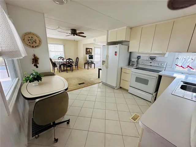 a kitchen with a sink appliances and cabinets