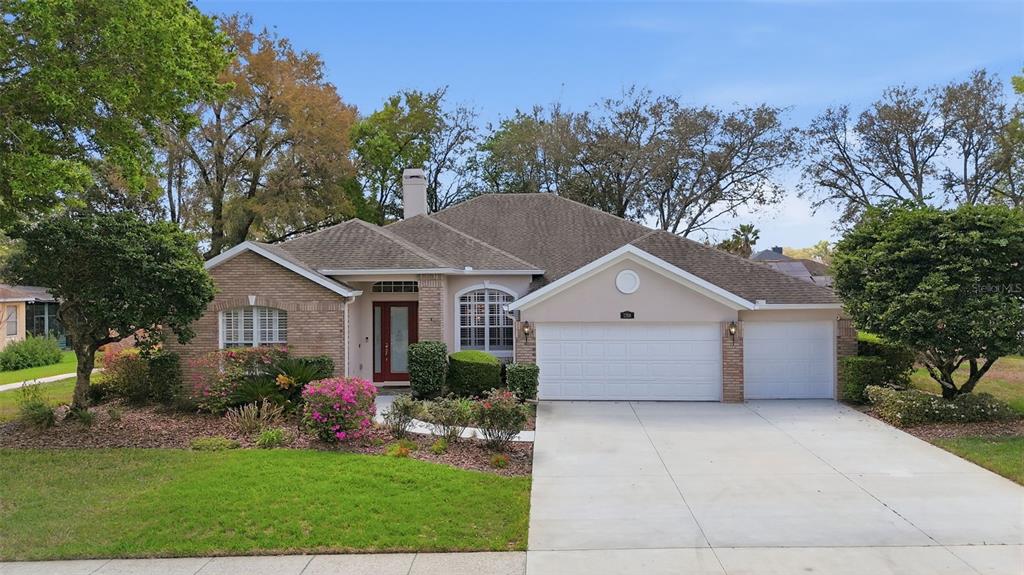 a front view of house with a garden and plants