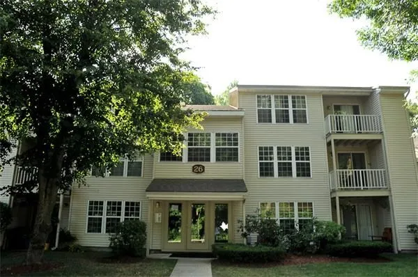 a front view of a residential apartment building with a yard