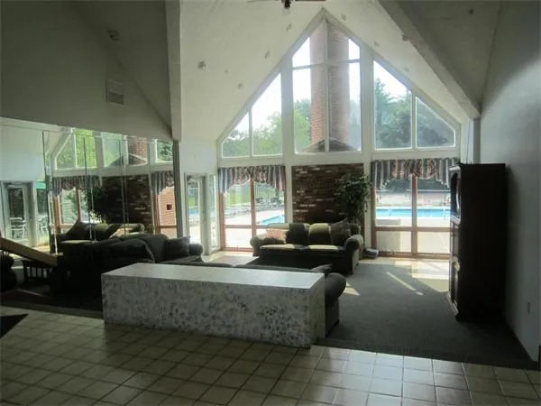a living room with fireplace furniture and a floor to ceiling window