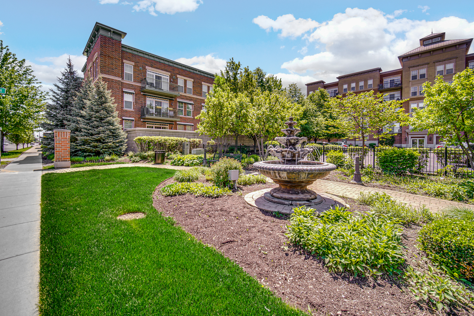 133 West Palatine Road, Unit 102 Palatine, IL 60067 - Photo 12 of 21 a front view of a house with a garden and fountain
