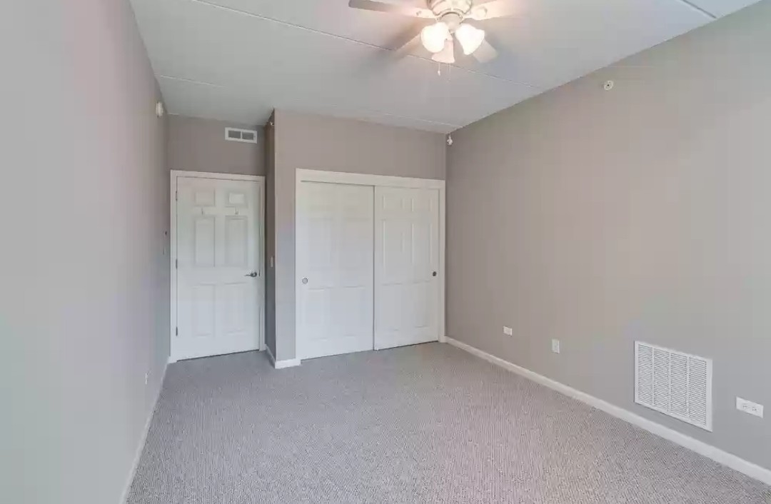 133 West Palatine Road, Unit 102 Palatine, IL 60067 - Photo 18 of 21 an empty room with a chandelier fan
