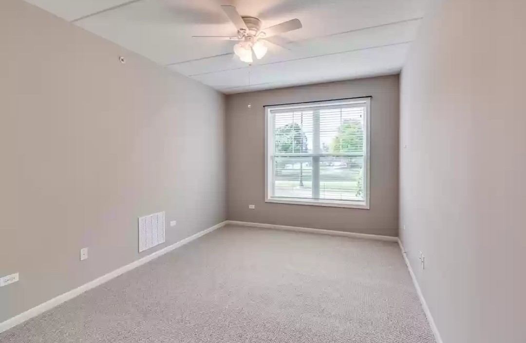 133 West Palatine Road, Unit 102 Palatine, IL 60067 - Photo 6 of 21 a view of room with a ceiling fan and window