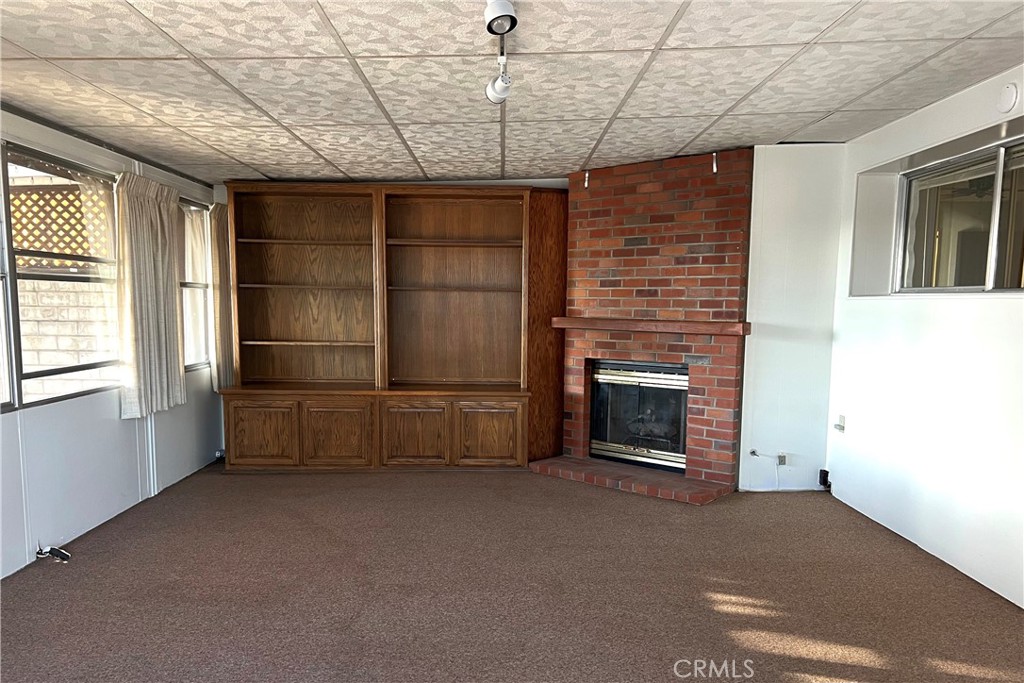 217 Hope Way Nipomo, CA 93444 - Photo 6 of 15 a view of empty room with a fireplace and windows
