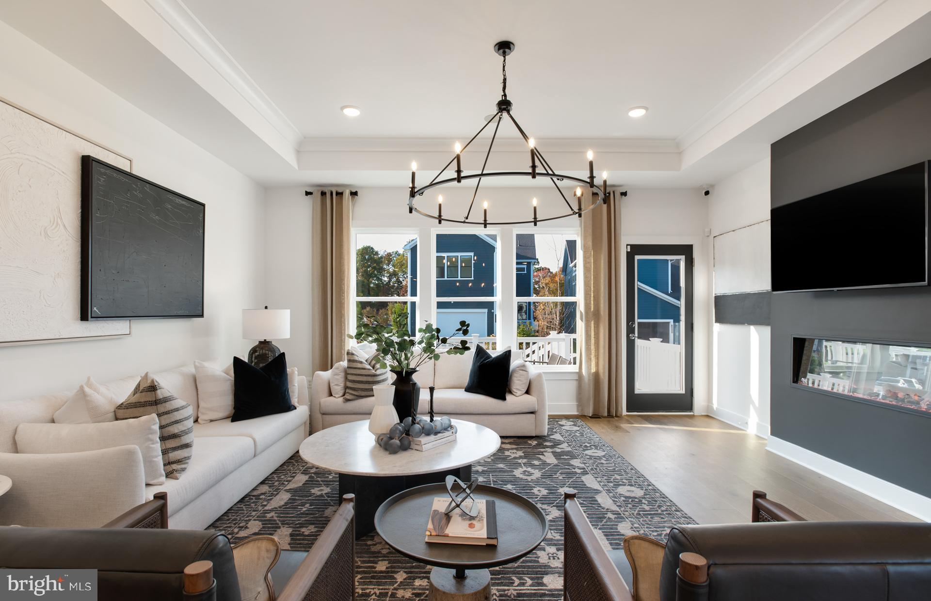 18260 Hobbes Rst Lane Leesburg, VA 20176 - Photo 20 of 63 a living room with furniture a flat screen tv and a large window