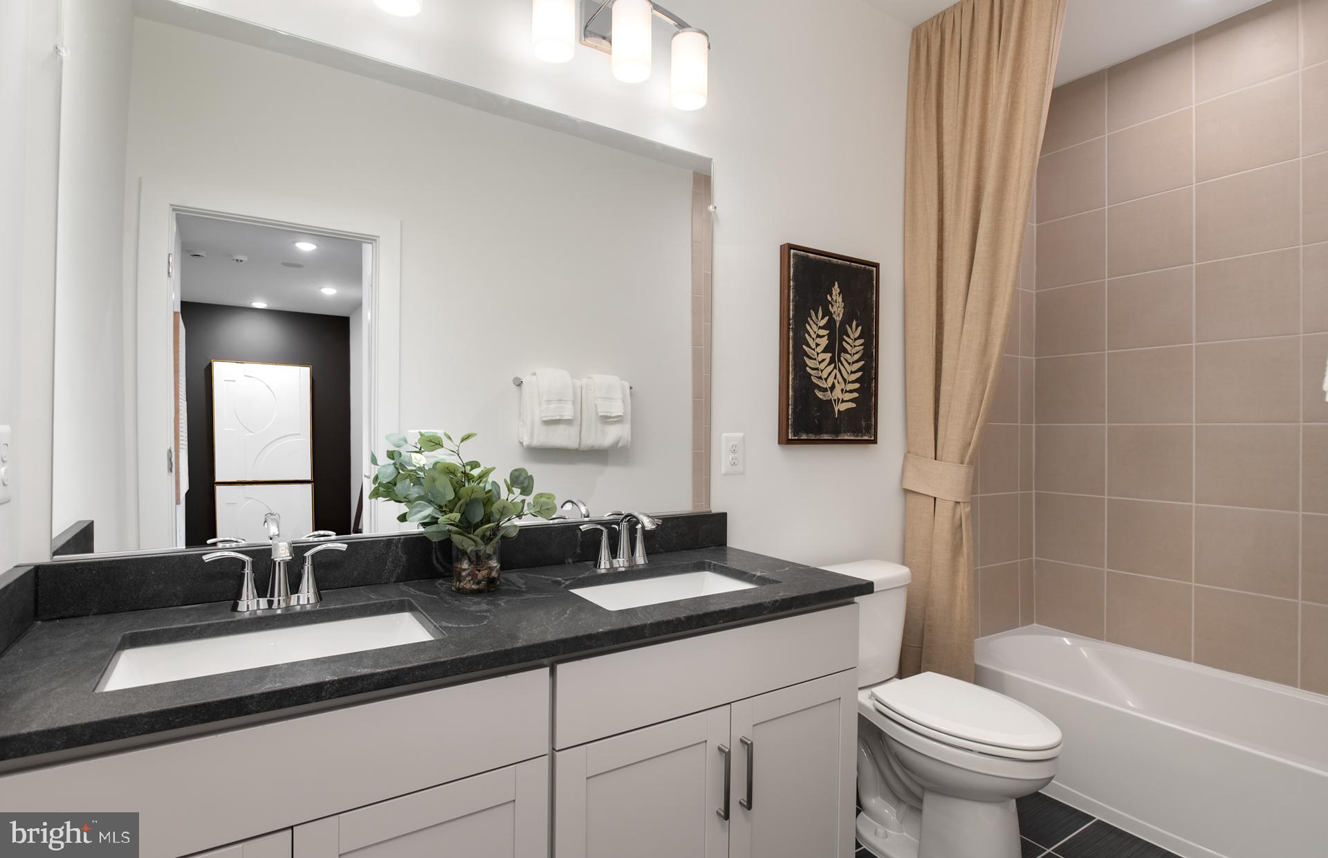 18260 Hobbes Rst Lane Leesburg, VA 20176 - Photo 35 of 63 a bathroom with a double vanity sink toilet and a mirror