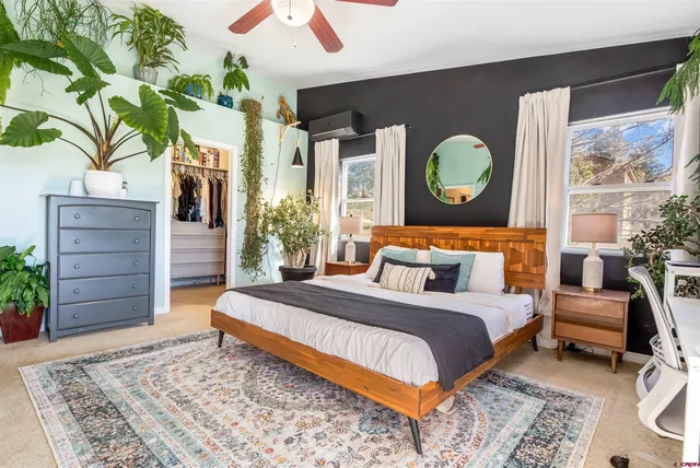 a bedroom with a bed and a dresser