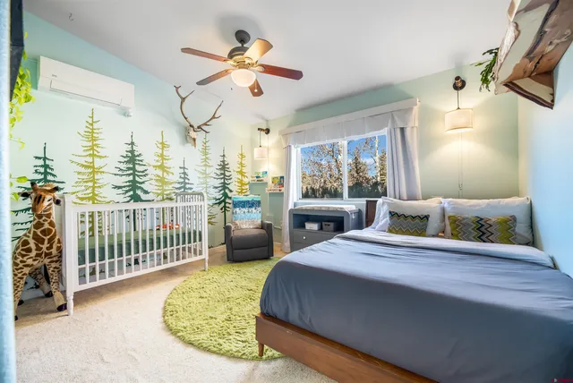 a bedroom with a bed and a chandelier