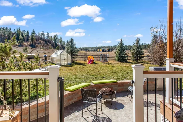 a view of a balcony with lake view and wooden floor