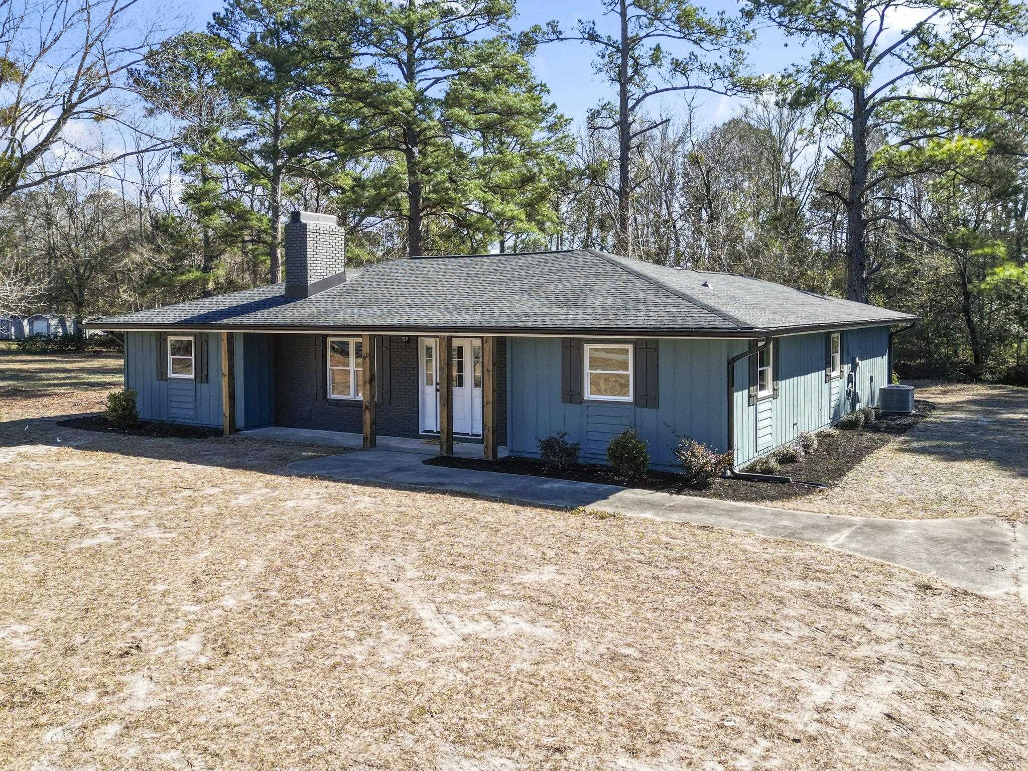 947 Fox Hollow Road Conway, SC 29526 - Photo 1 of 40 Ranch-style home featuring a chimney, a shingled roof, and covered porch