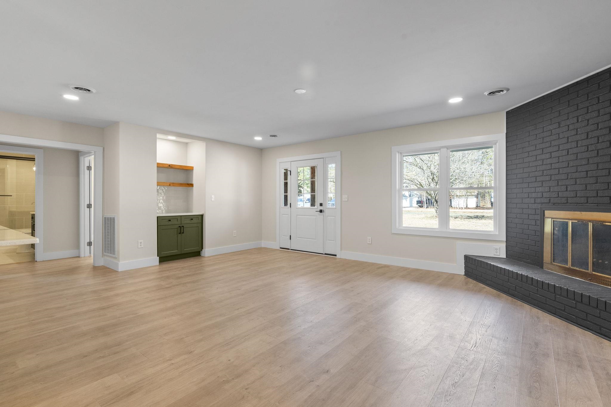 947 Fox Hollow Road Conway, SC 29526 - Photo 11 of 40 Unfurnished living room featuring a brick fireplace, light wood-style floors, and recessed lighting