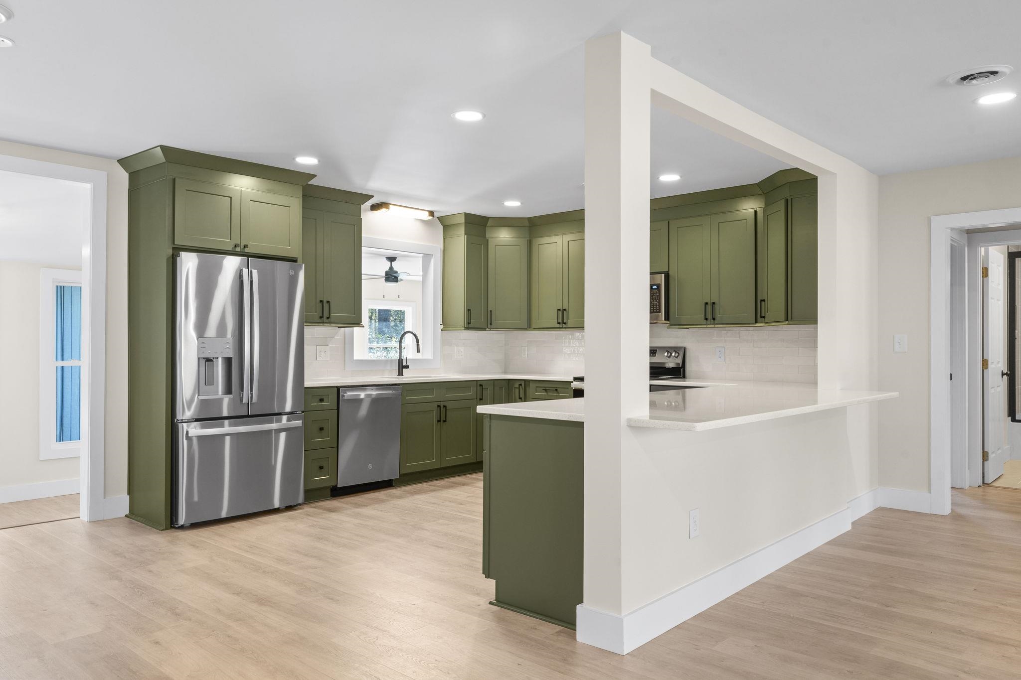 947 Fox Hollow Road Conway, SC 29526 - Photo 13 of 40 Kitchen with green cabinetry, appliances with stainless steel finishes, light wood-type flooring, and recessed lighting