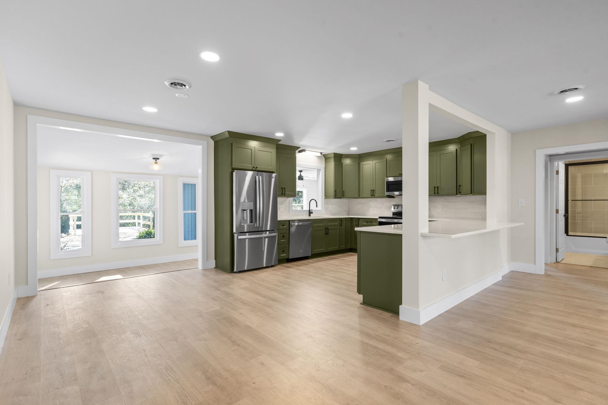 947 Fox Hollow Road Conway, SC 29526 - Photo 40 of 40 Kitchen with green cabinets, stainless steel appliances, light wood-style flooring, open floor plan, and recessed lighting