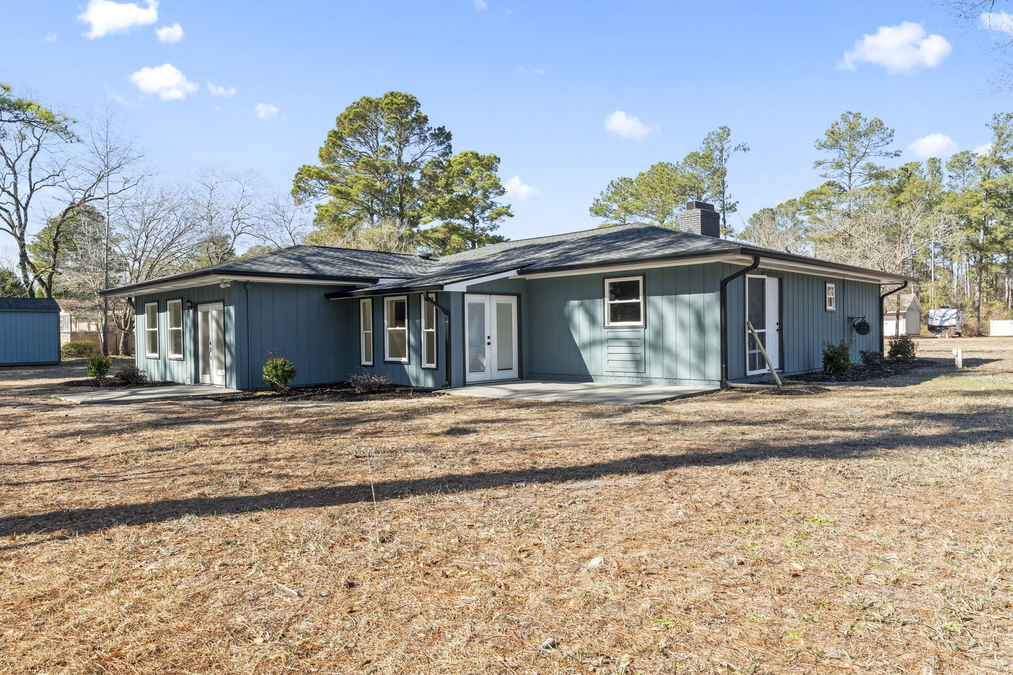 947 Fox Hollow Road Conway, SC 29526 - Photo 30 of 40 Rear view of property featuring a chimney, french doors, and a patio area