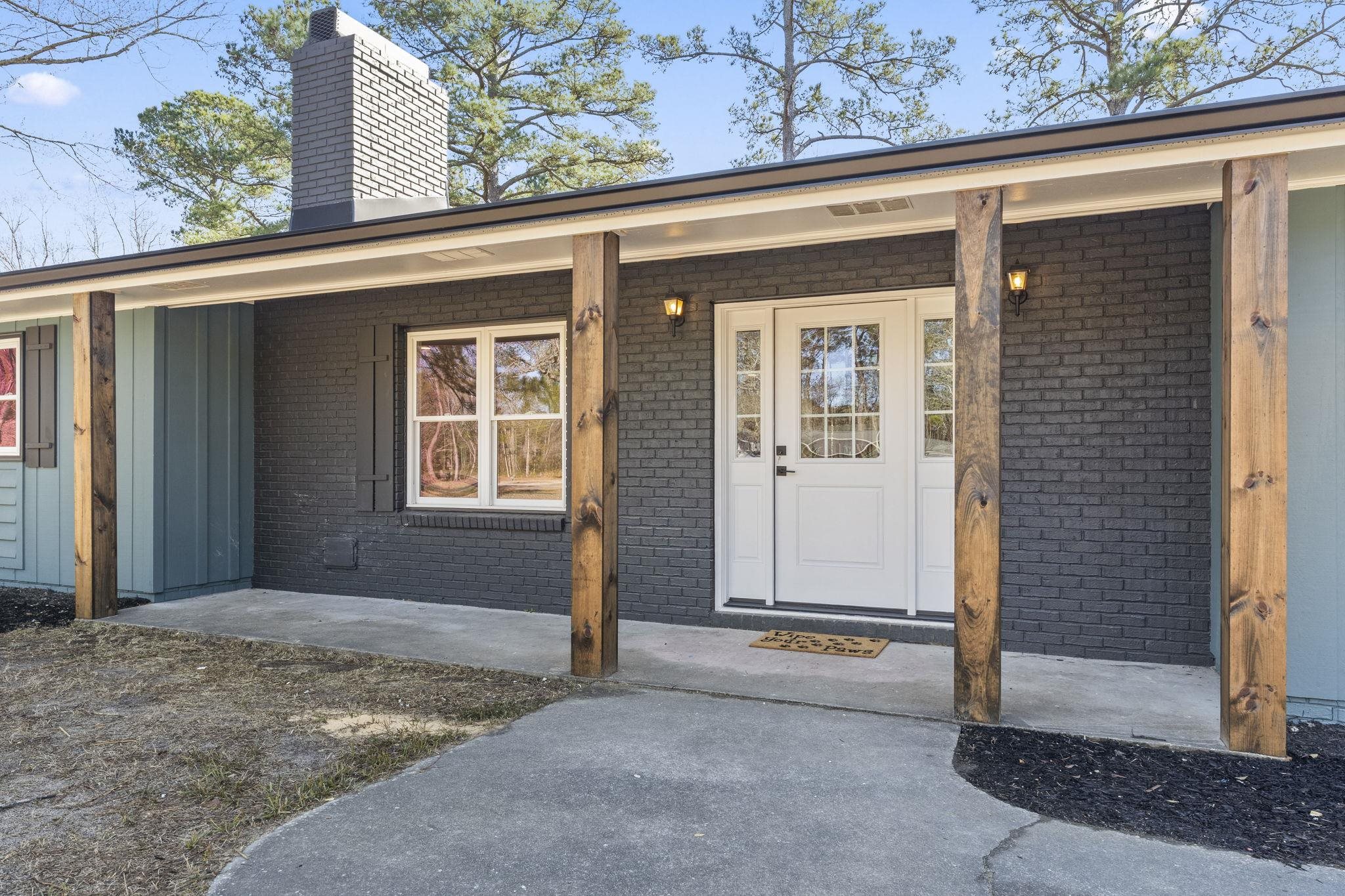 947 Fox Hollow Road Conway, SC 29526 - Photo 6 of 40 Entrance to property featuring a chimney, brick siding, and covered porch