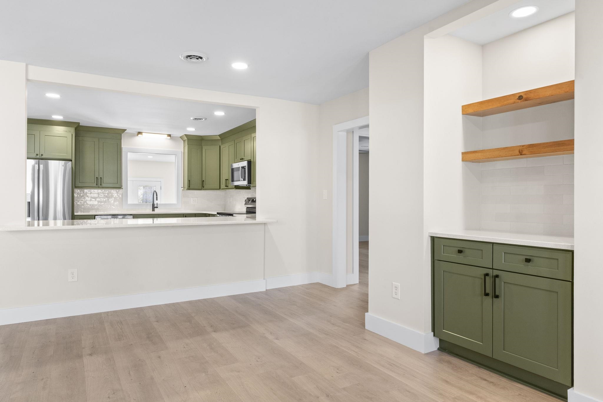 947 Fox Hollow Road Conway, SC 29526 - Photo 8 of 40 Kitchen featuring green cabinets, decorative backsplash, recessed lighting, open shelves, and stainless steel appliances