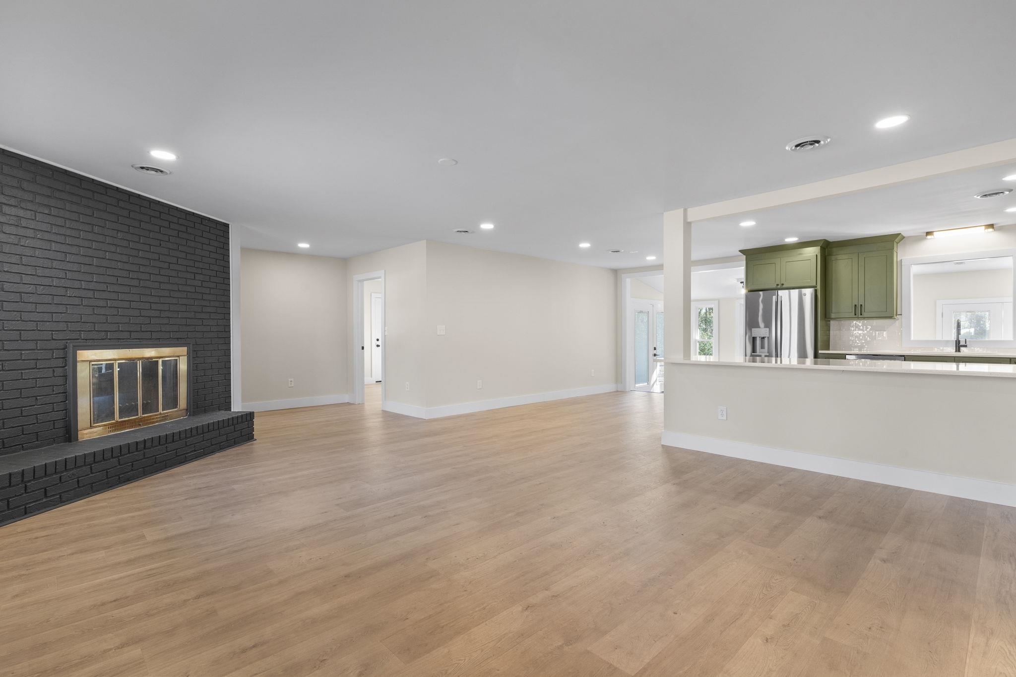 947 Fox Hollow Road Conway, SC 29526 - Photo 9 of 40 Unfurnished living room with a brick fireplace, light wood-type flooring, and recessed lighting