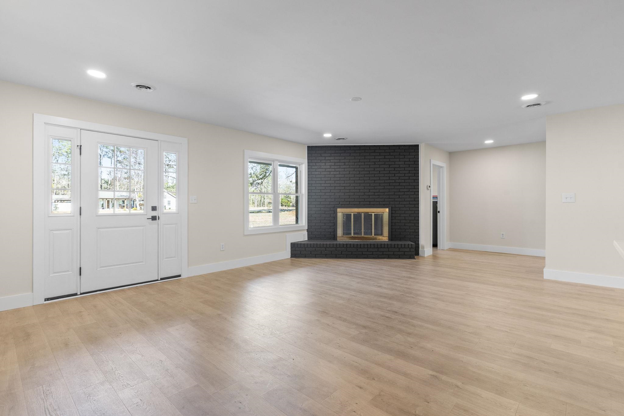 947 Fox Hollow Road Conway, SC 29526 - Photo 10 of 40 Unfurnished living room with a brick fireplace, light wood-type flooring, and recessed lighting