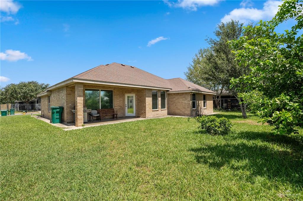 6707 South Rios Street Pharr, TX 78577 - Photo 13 of 17 a front view of a house with a garden