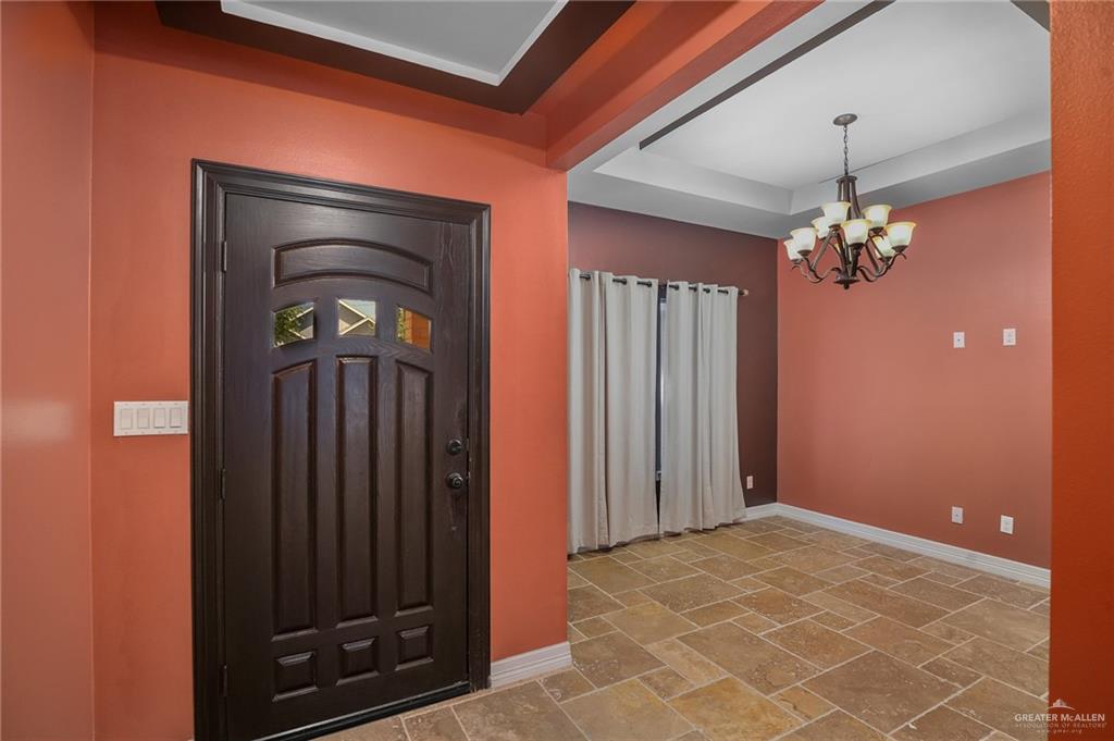 6707 South Rios Street Pharr, TX 78577 - Photo 3 of 17 a view of a hallway with a chandelier