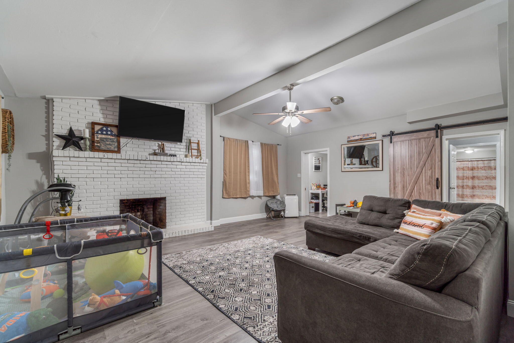 128 Sikes Drive Crestview, FL 32539 - Photo 4 of 24 a living room with furniture a flat screen tv and a fireplace