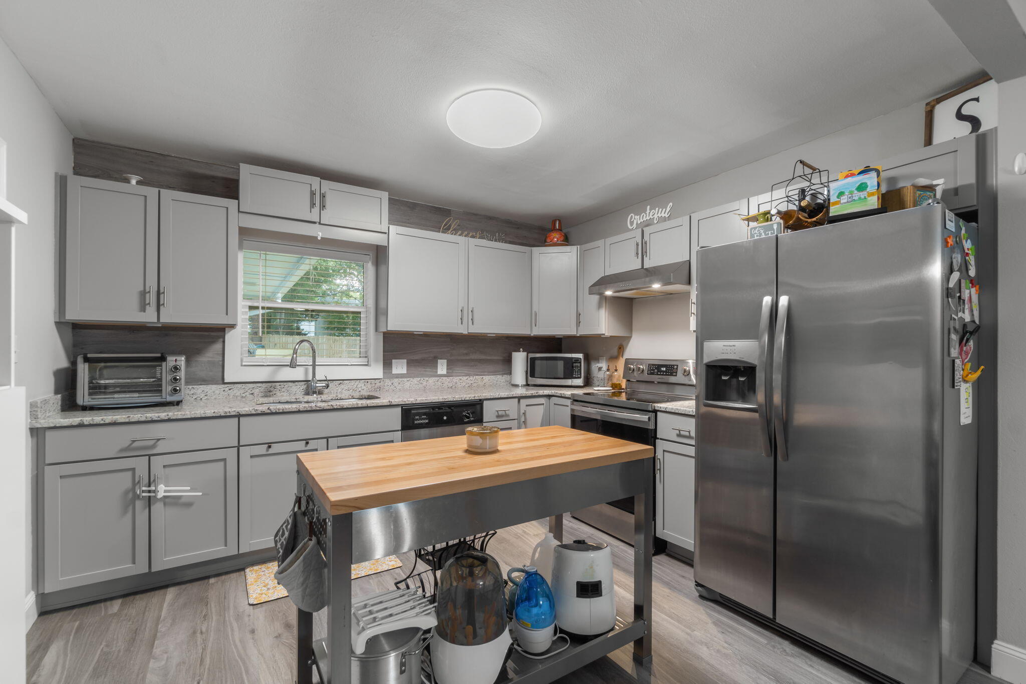 128 Sikes Drive Crestview, FL 32539 - Photo 8 of 24 a kitchen with stainless steel appliances a refrigerator sink and cabinets
