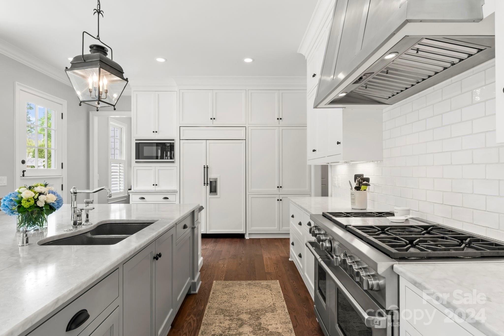 905 Martingale Lane Davidson, NC 28036 - Photo 15 of 45 a kitchen with stainless steel appliances granite countertop a sink stove and refrigerator