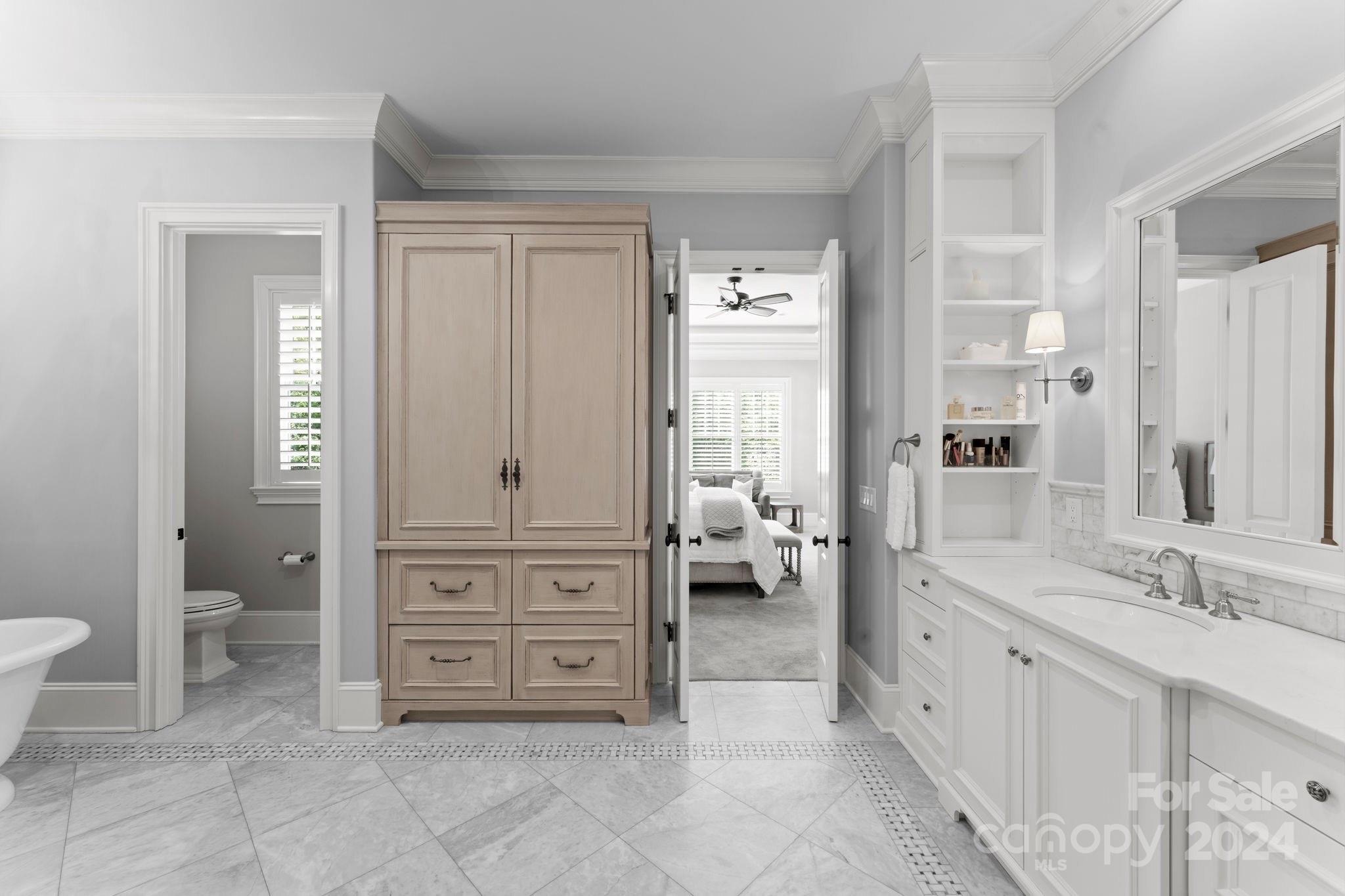 905 Martingale Lane Davidson, NC 28036 - Photo 23 of 45 a spacious bathroom with a granite countertop sink a toilet and a mirror