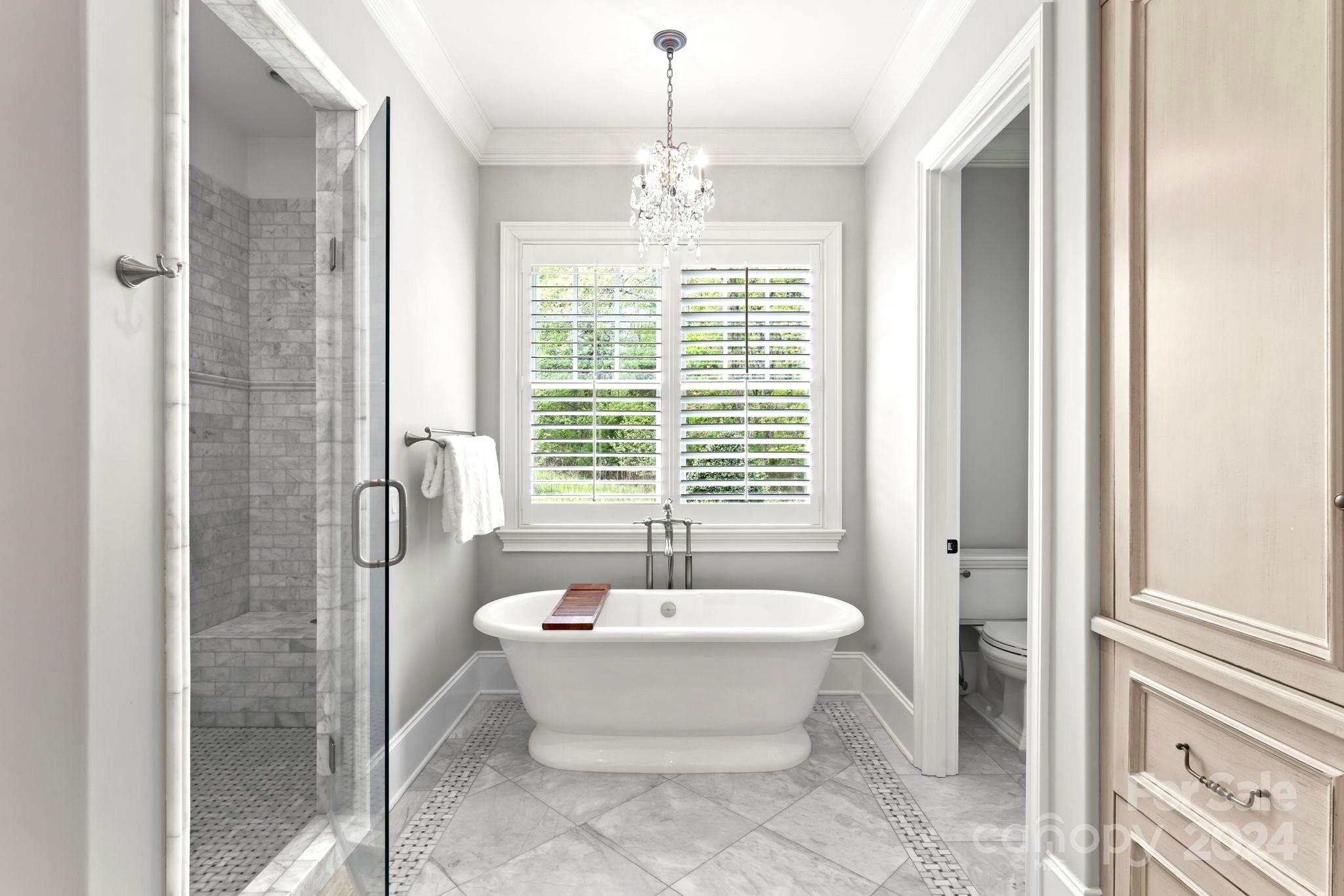 905 Martingale Lane Davidson, NC 28036 - Photo 24 of 45 a spacious bathroom with a bathtub and window