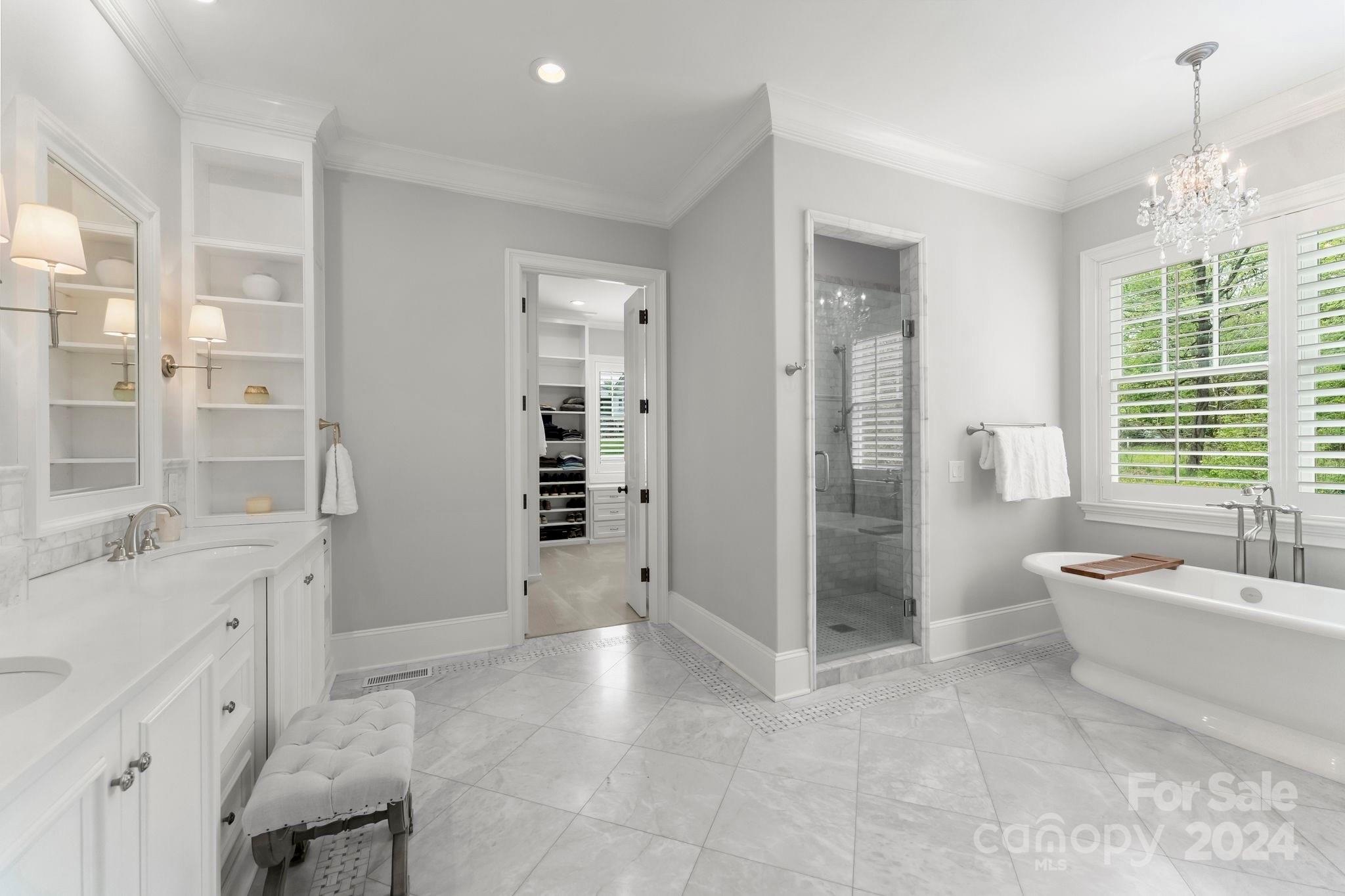 905 Martingale Lane Davidson, NC 28036 - Photo 26 of 45 a spacious bathroom with a bathtub sink and mirror