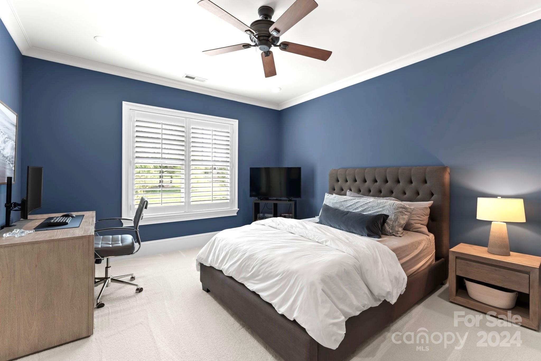905 Martingale Lane Davidson, NC 28036 - Photo 35 of 45 a spacious bedroom with a bed and a chandelier
