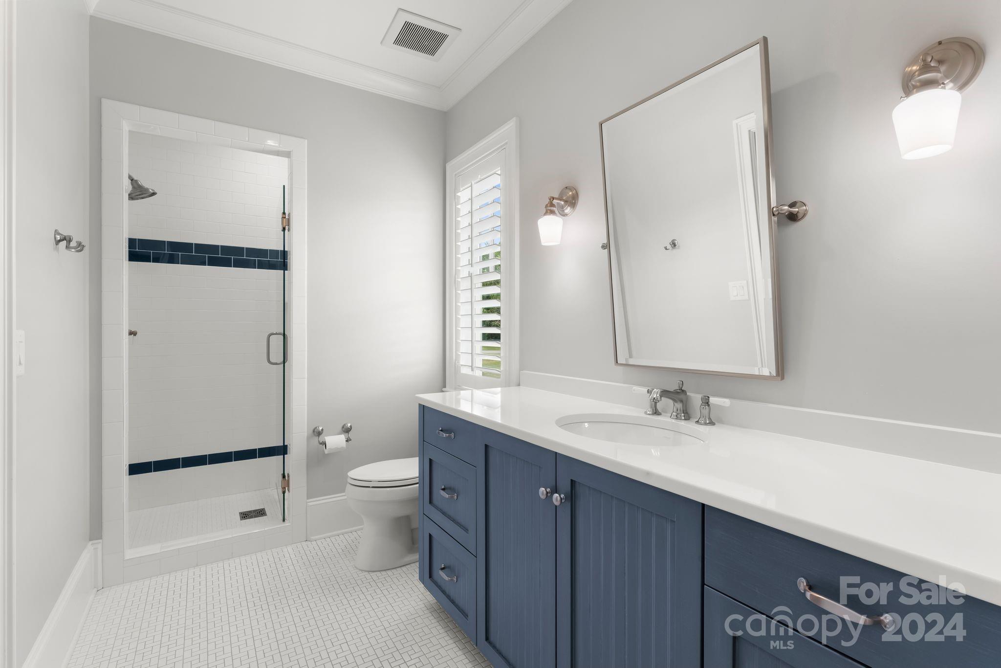 905 Martingale Lane Davidson, NC 28036 - Photo 36 of 45 a bathroom with a double vanity sink toilet mirror and shower